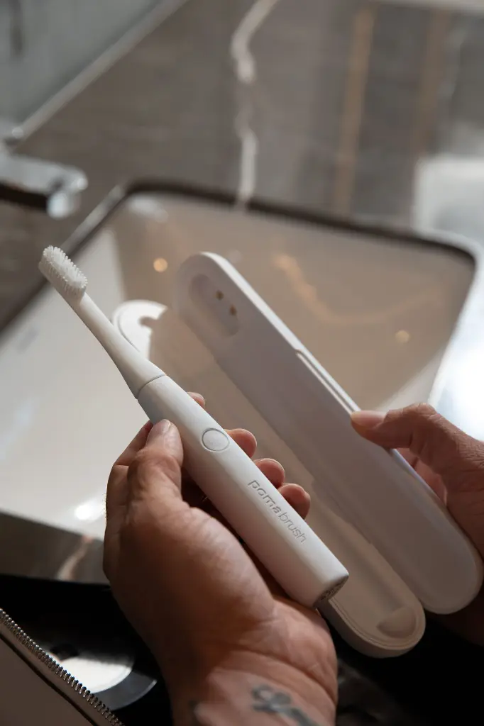 Man holding White Pomabrush.webp