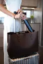 woman packing pomabrush into her travel luggage.webp